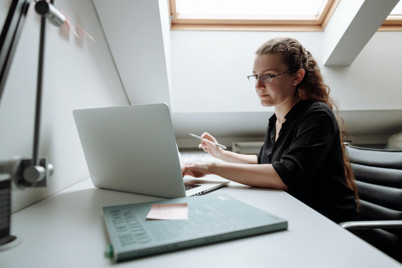 A young lady seated using a laptop