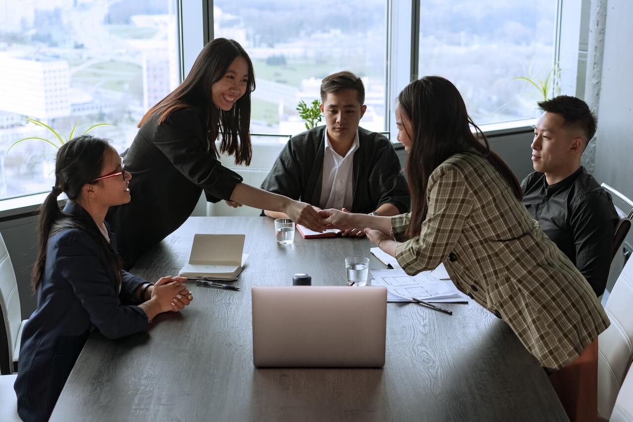 Business women shaking hands in a meeting