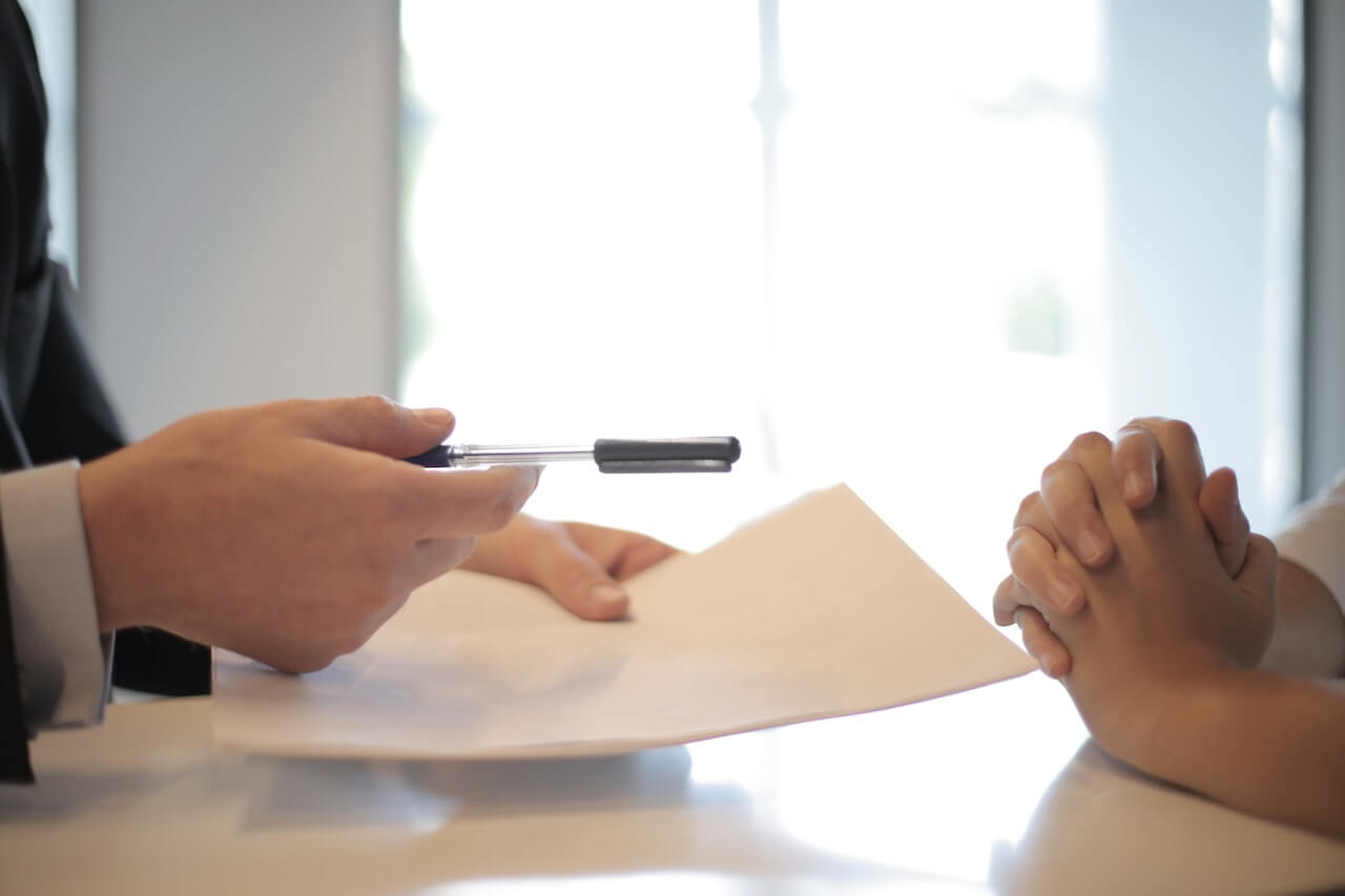 businessman giving contract to woman to sign