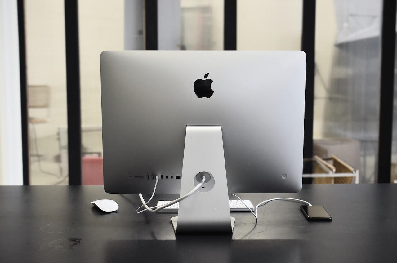 computer on table with smartphone in office