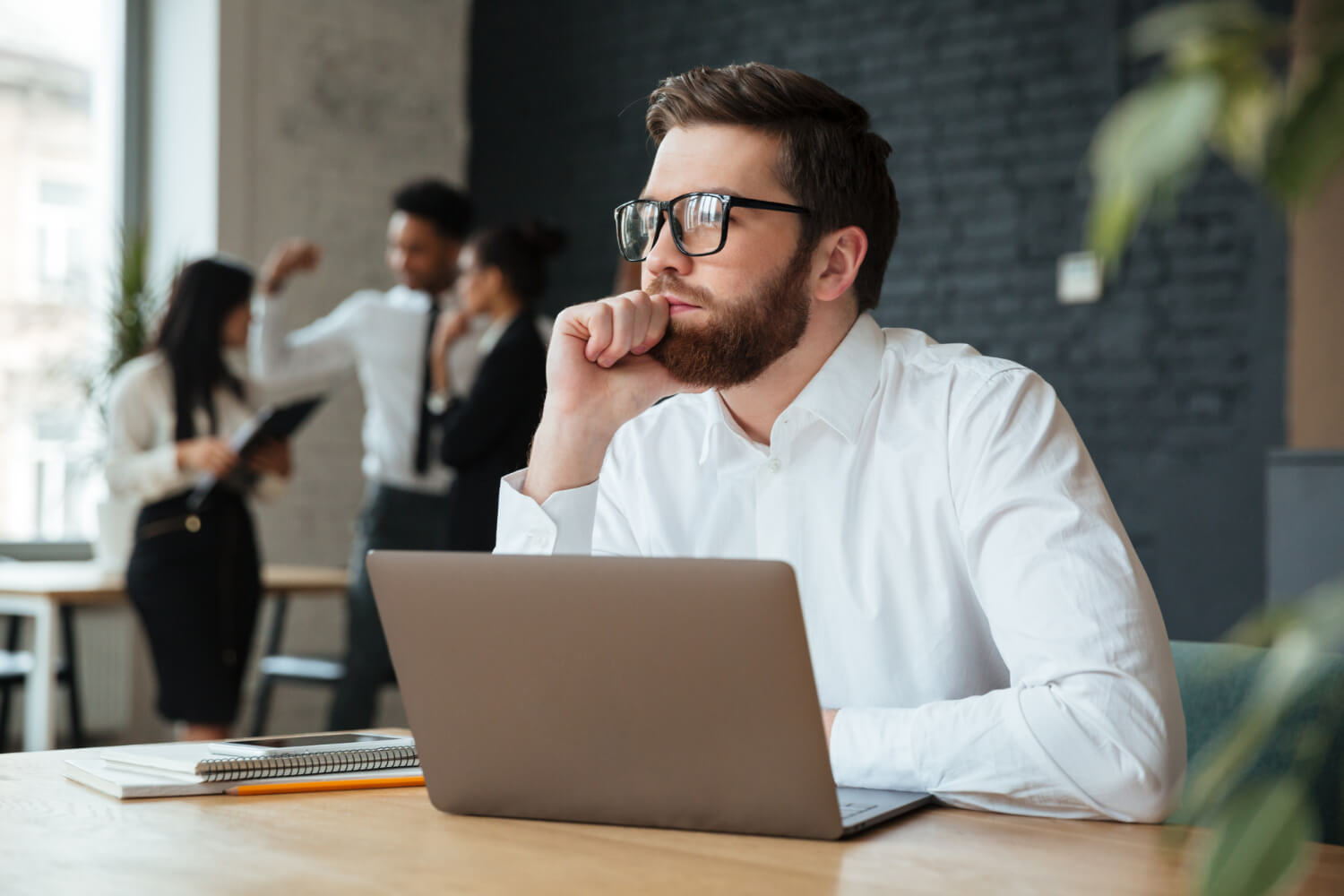 Focused young businessman thinking