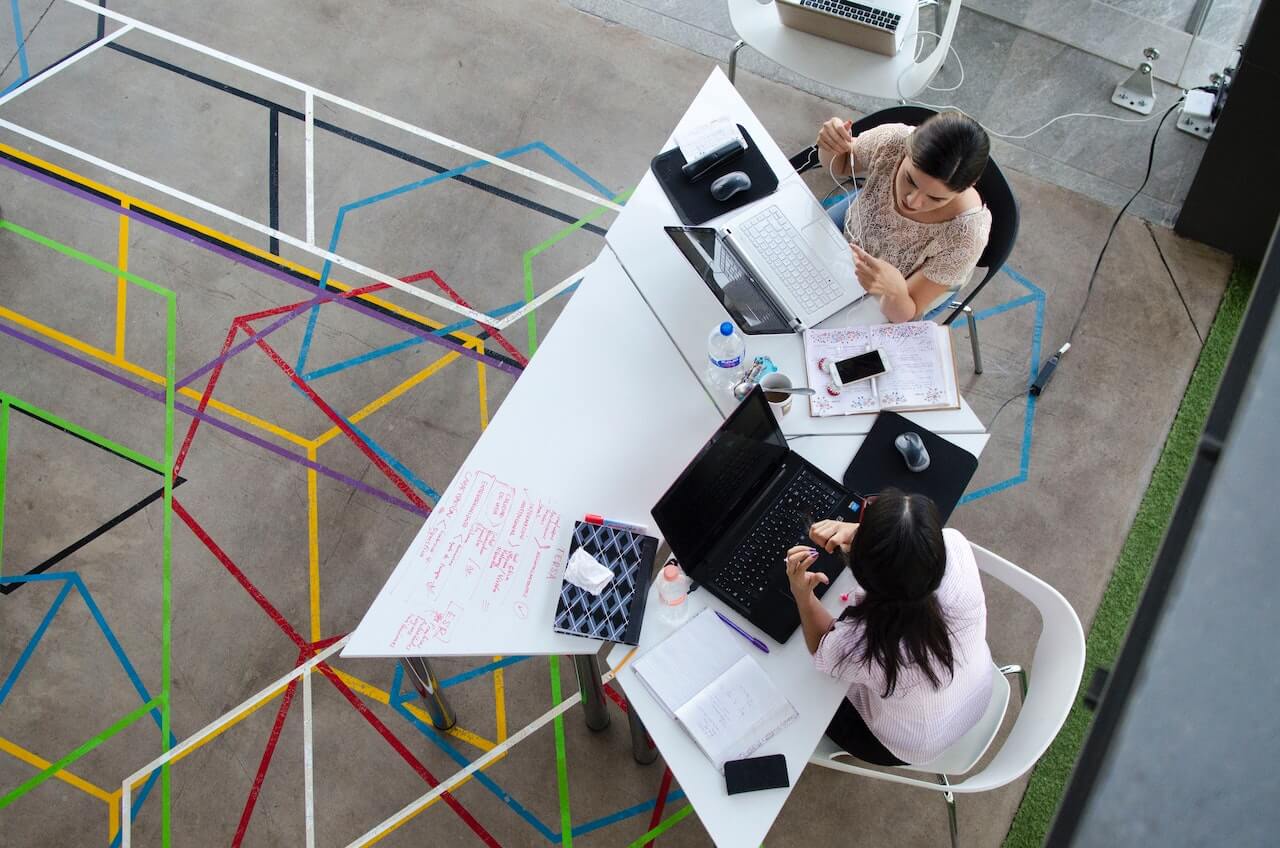 Two women sitting and working together