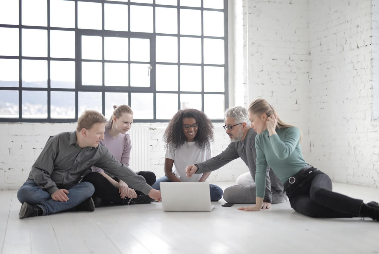 Group Of People Having A Discussion While Seated On The Floor