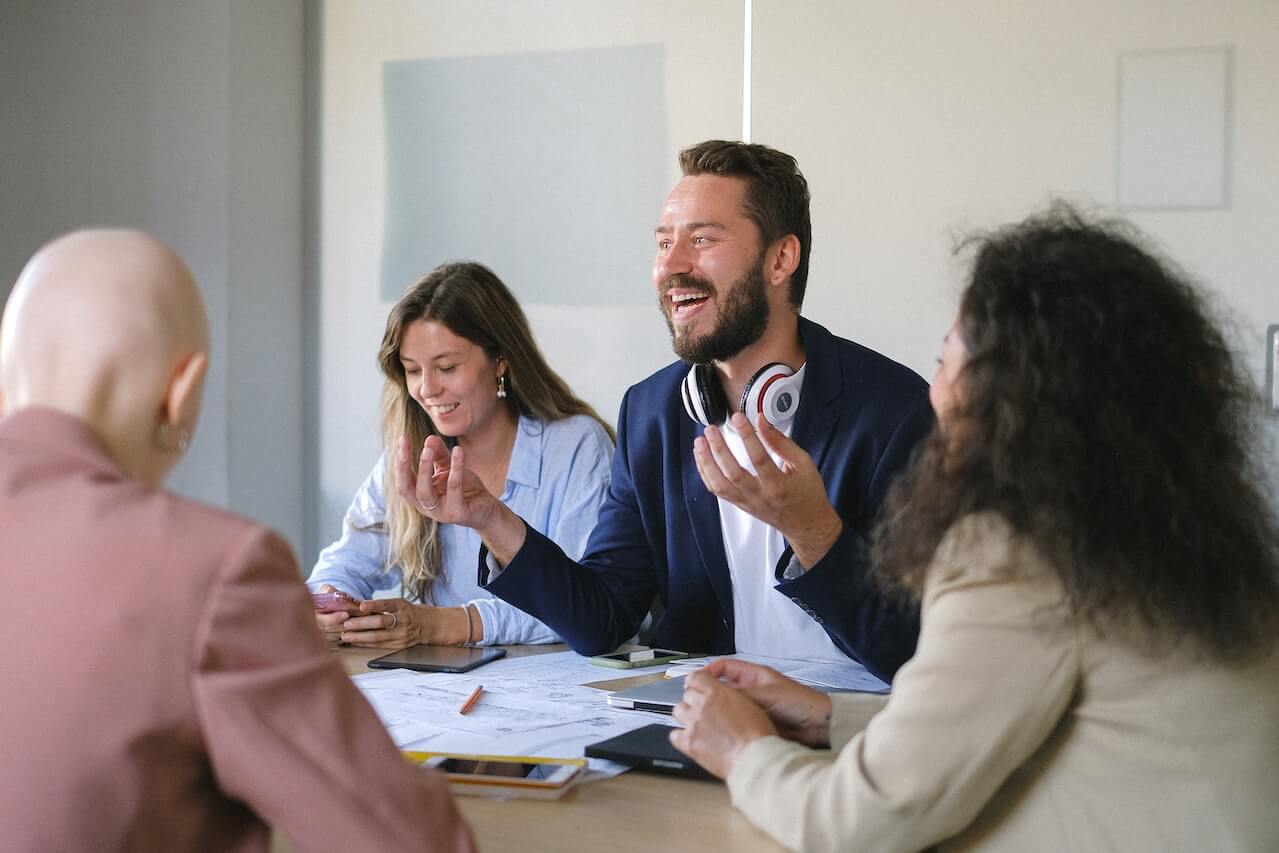 Group of cheerful businesspeople discussing