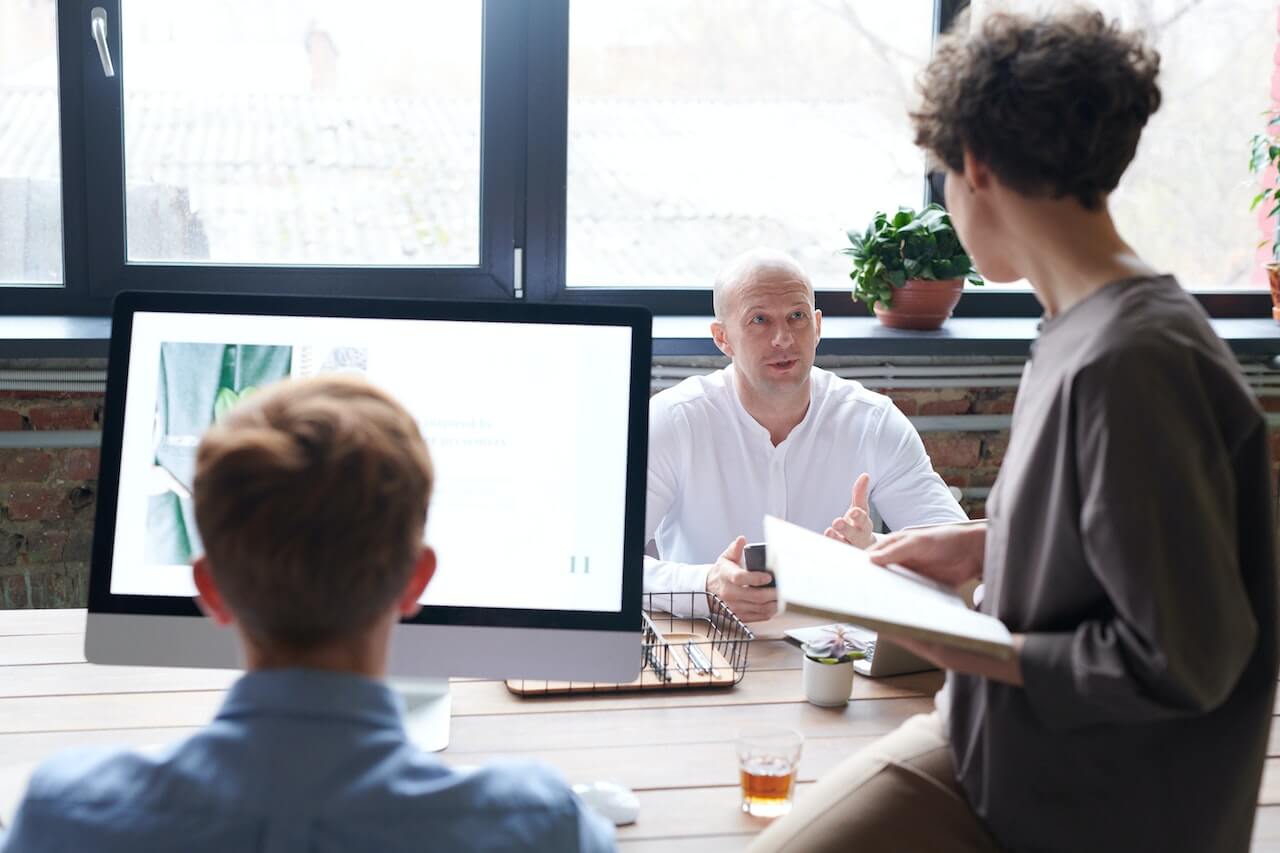 People Near Wooden Table in a Meeting