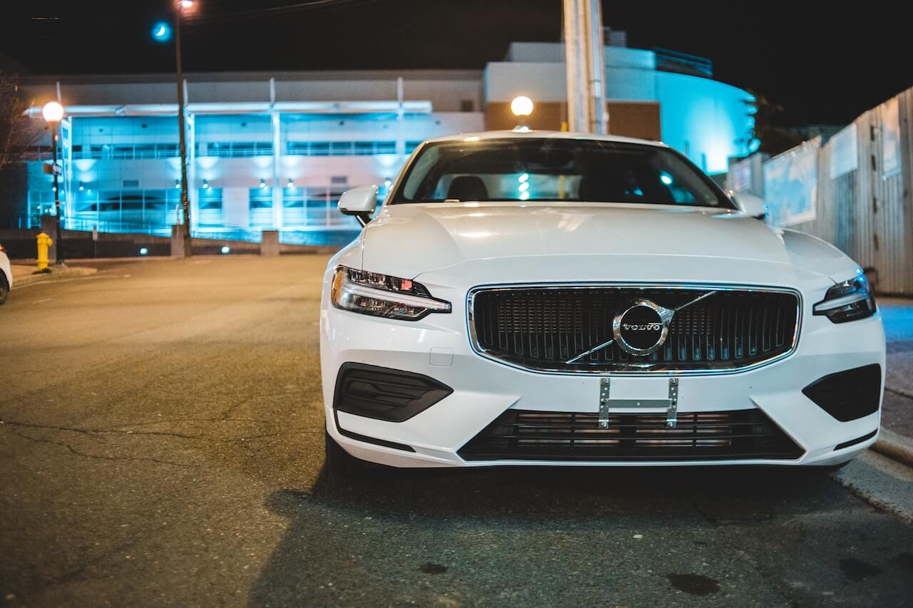 White Volvo car parked by roadside