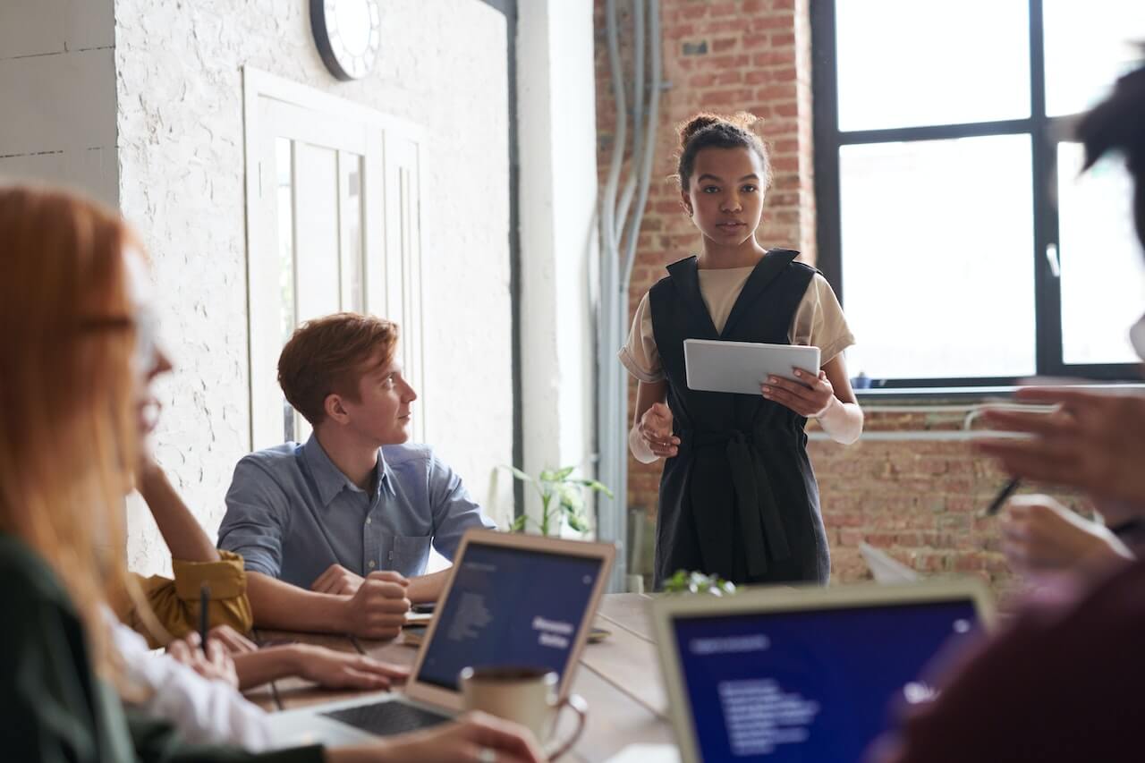 Woman holding portable pad in a meeting