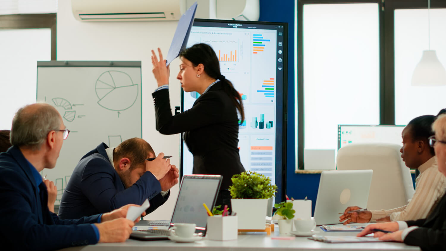 colleagues-having-conflict-dispute-about-document-in-a-boardroom