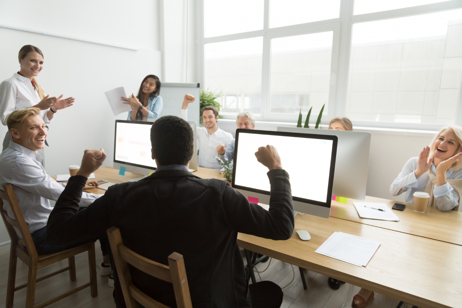 olleagues-congratulating-black-coworker-with-good-result-win