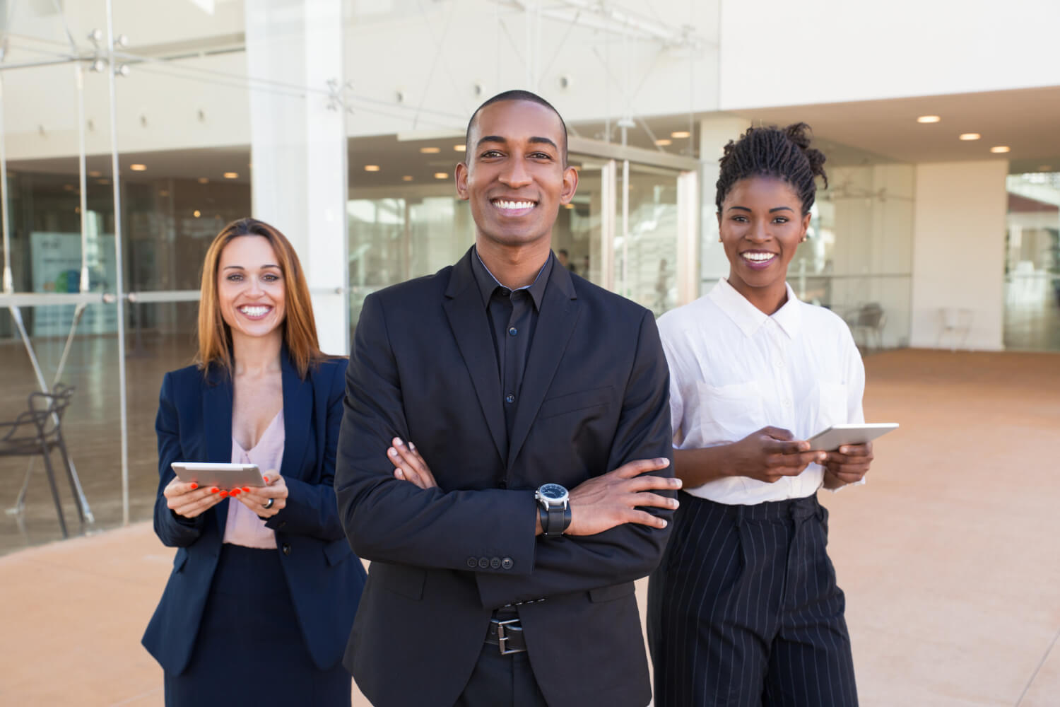 happy-cheerful-business-people-posing-office-hallway