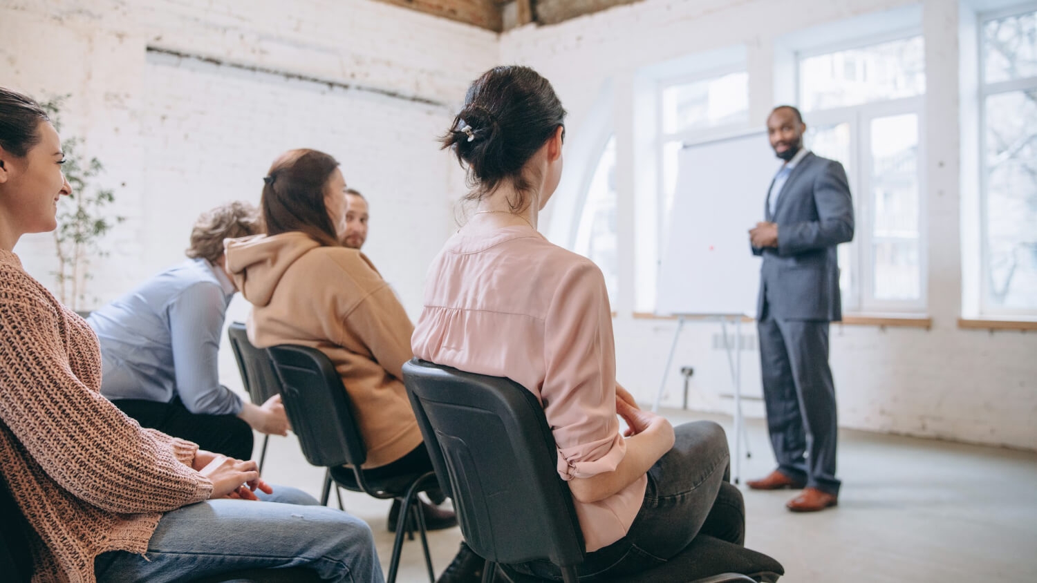 male-speaker-giving-presentation-to-an-audience-in-a-conference-hall-