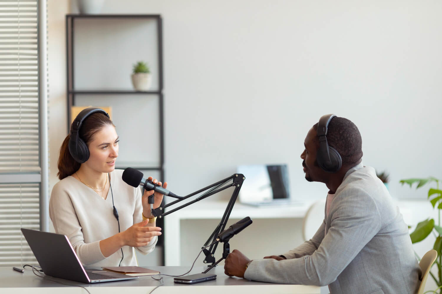 A man doing a podcast with a female reporter