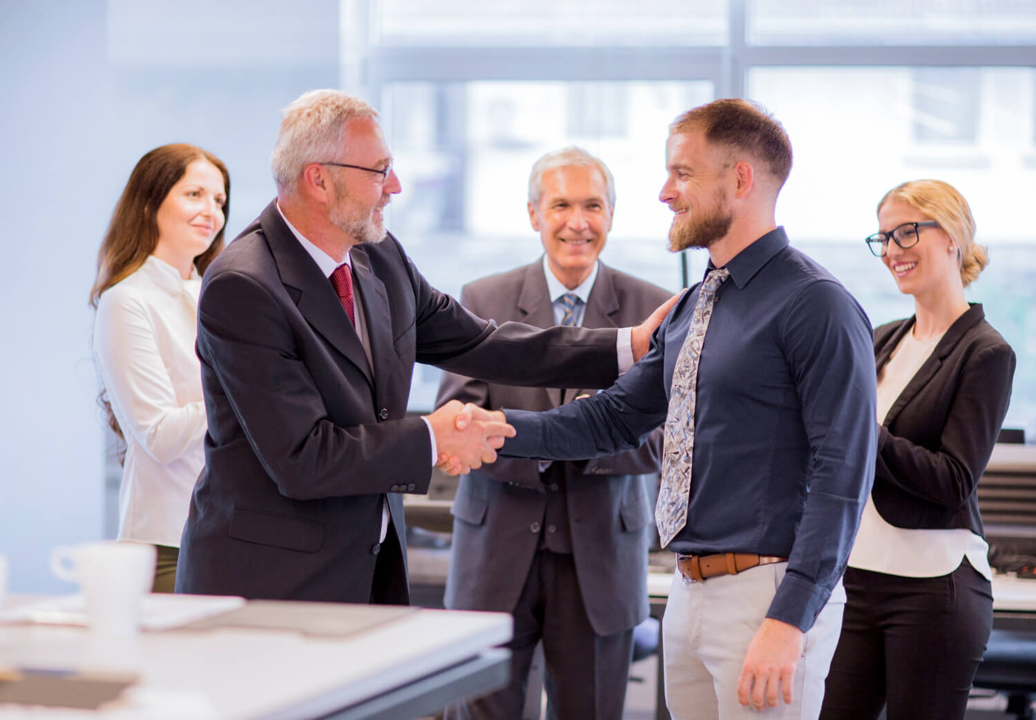 Two-businessmen-shaking-hands-congratulating-promotion.