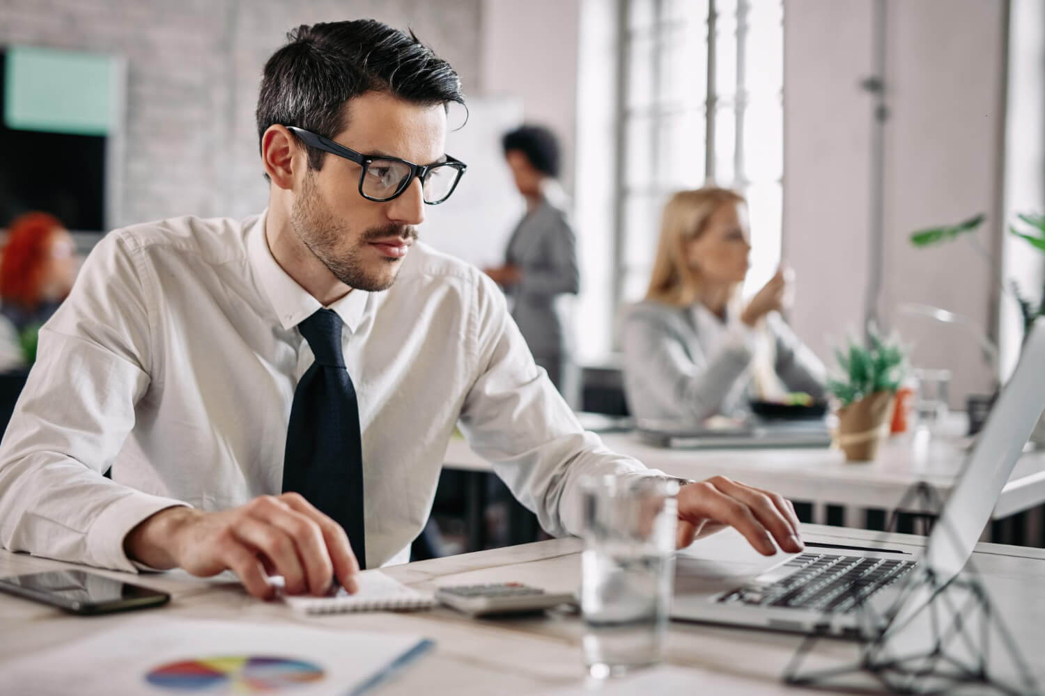 young-businessman-working-business-reports-using-computer