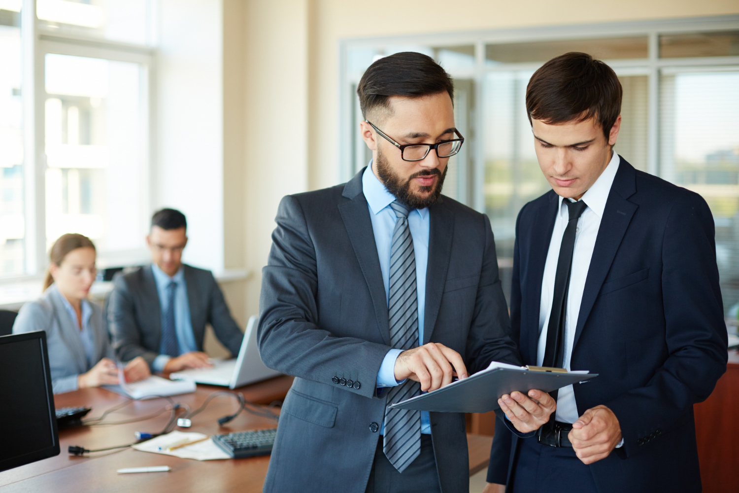 Businessman showing a bank report to another