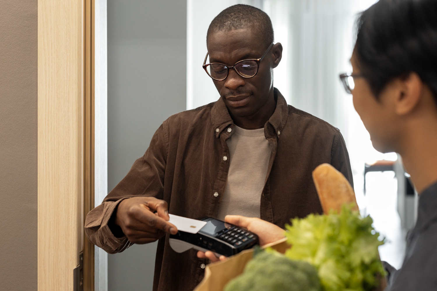 Man paying for groceries with a POS system